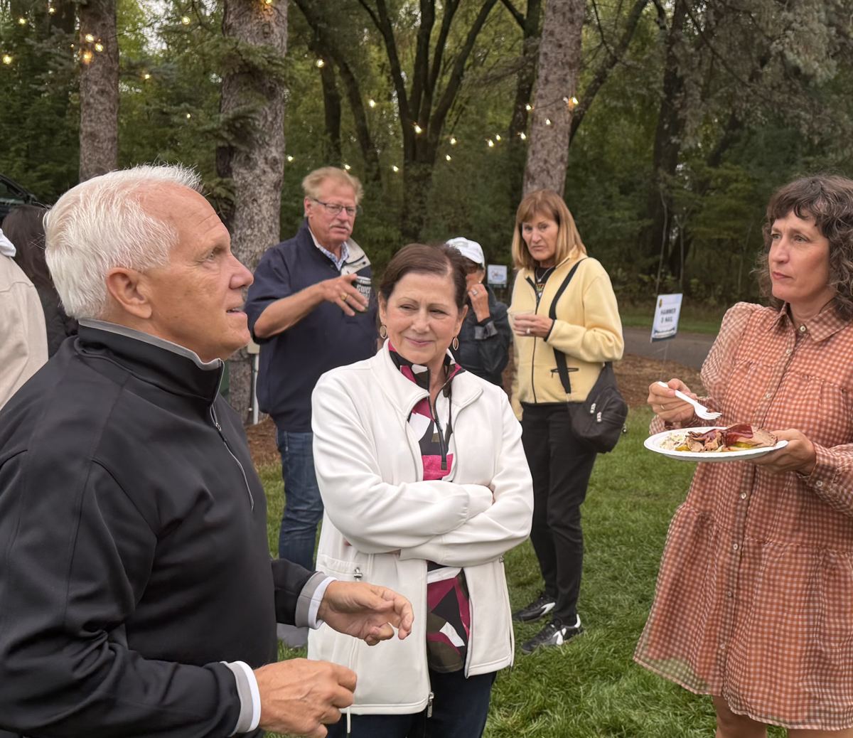 Jenny Peterson talking with neighbors at an outdoor community event